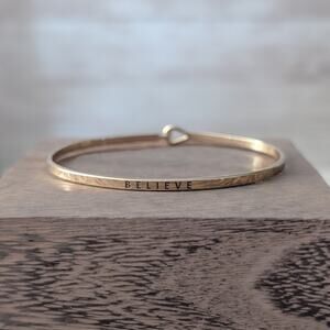 Gold Tone Believe Bangle Bracelet - 6.75"